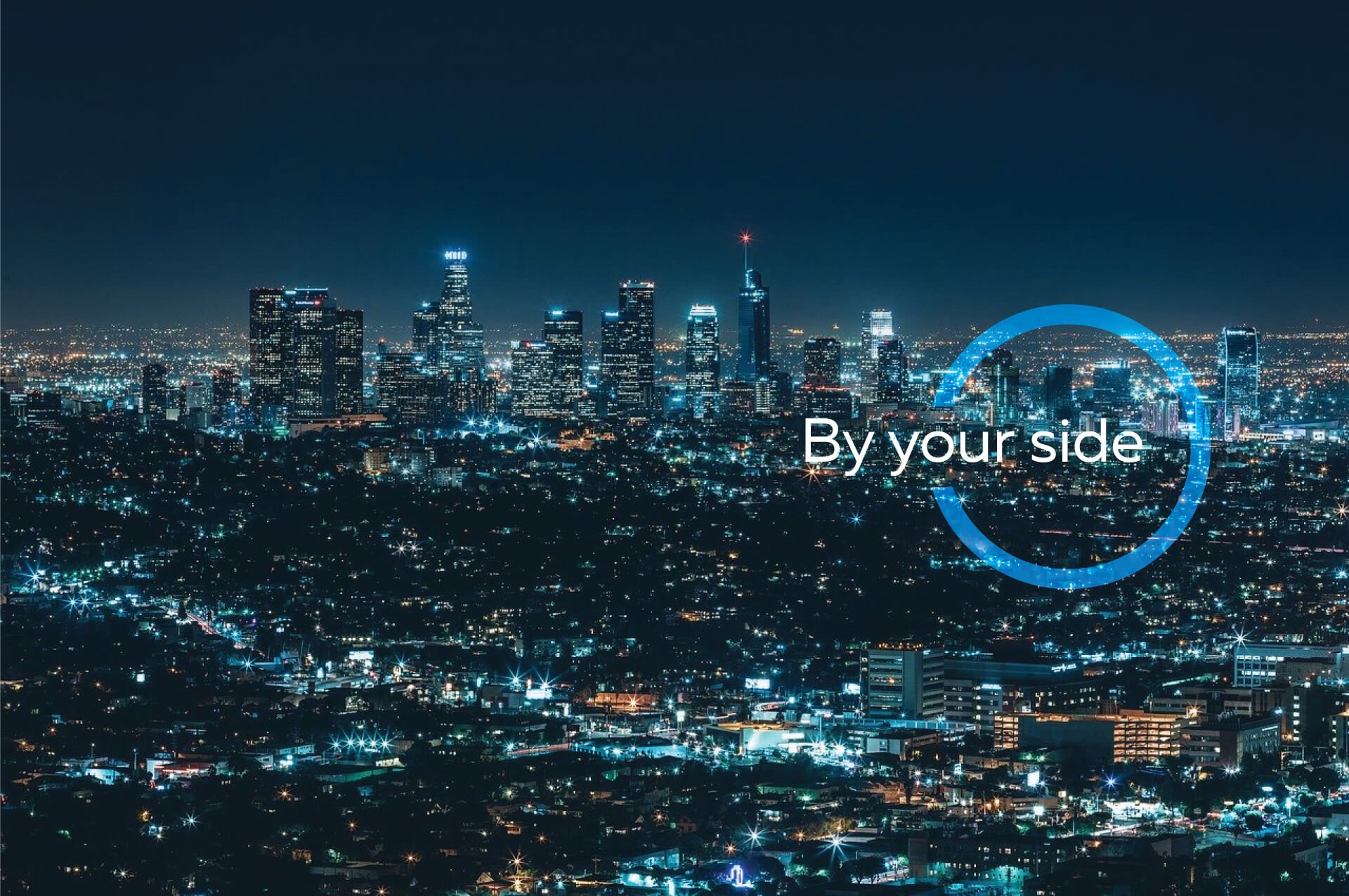 the "by your side" logo against a nighttime city backdrop
